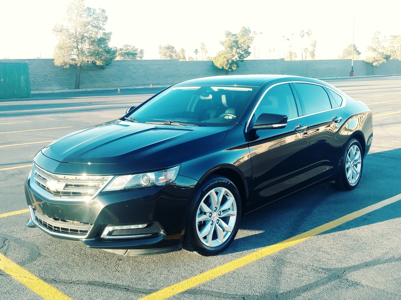 Freshly washed black Chevrolet Impala parked in the lot